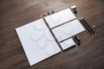 Blank corporate stationery set on wood table background. Corporate identity template. Responsive design mockup.