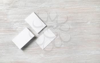 Photo of blank business cards on light wooden background. Template for ID. Copy space for text. Flat lay.
