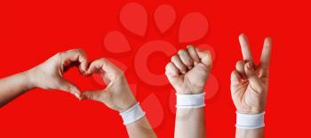 We believe, we can, we will win. Female hands with white bracelets on red background. Revolution of consciousness in Belarus.