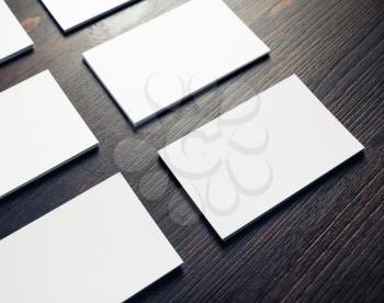 Stacks of blank business cards on wood table background. Mockup for branding identity.