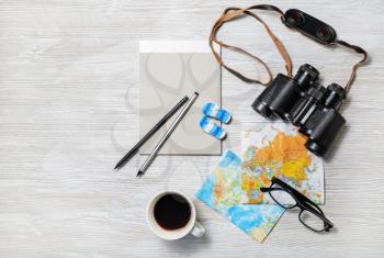 Preparation for travel. Trip vacation accessories and items on light wooden table background. Top view. Flat lay.