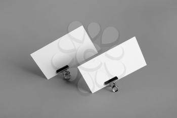Photo of two blank business cards on gray paper background. Branding ID template.