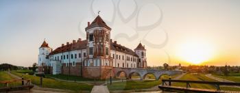 Mir, Belarus - August 11, 2017: Ancient medieval castle on a sunset background. Fortress in Mir, Belarus. UNESCO world heritage site. Panoramic shot.