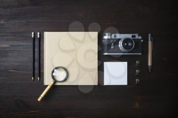 Travel stationery concept. Vintage camera, accessories and items on wooden background. Flat lay.