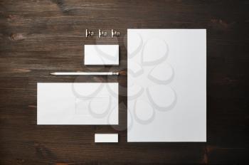 Photo of blank stationery set on wood table background. Corporate identity mock up for placing your design. Top view. Flat lay.