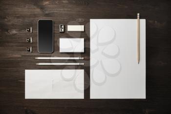 Blank corporate stationery set on wood table background. Template for branding identity. Top view. Flat lay.