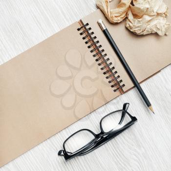 Blank notebook glasses, pencil and crumpled paper. Responsive design mockup. Stationery set. Template for placing your design. Top view. Flat lay.