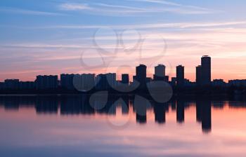 Modern skyscrapers meeting sunset light rays background