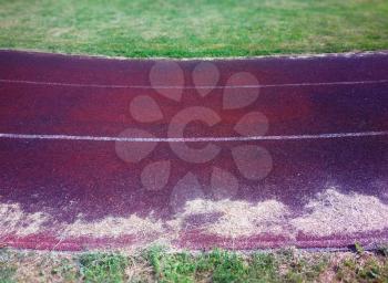 Curved sport track with dry grass background