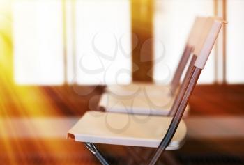 Horizontal office chairs with light leak bokeh background
