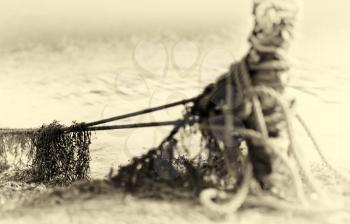 Tied up ship rope on Norway beach in sepia hd