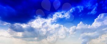 Horizontal vivid blue cloudscape dramatic clouds background backdrop