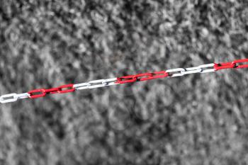 Diagonal red chain on black and white grass backdrop hd