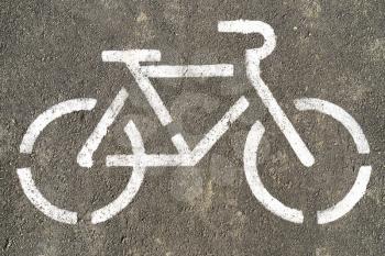 Bicycle symbol on textured asphalt background