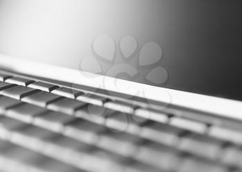 Perspective black and white  laptop keyboard bokeh background
