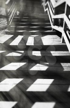 Vertical black and white stairs with dramatic light background