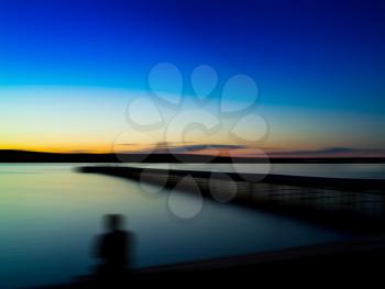 Horizontal vivid man's back shadow sitting on the quay motion abstraction background backdrop