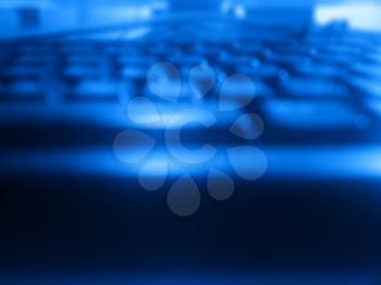 Dark blue computer keyboard bokeh background