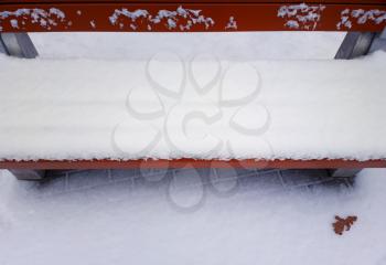 Park bench in snow winter background