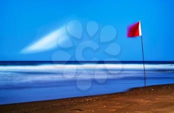 Horizontal red flag of freedom beach landscape background