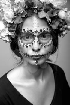 Fashion black and white portrait of a beautiful Halloween model with creative make up