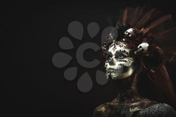 Santa Muerte Young Girl with Artistic Halloween Makeup and with Sculls in her Hair