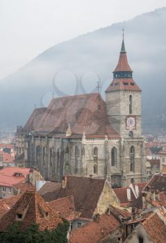 Black Church in a Brasov old town in a foggy winter day. Transylvania, Romania