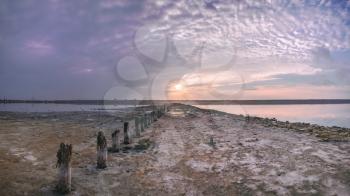 Shore and bottom of a drying lake at sunset