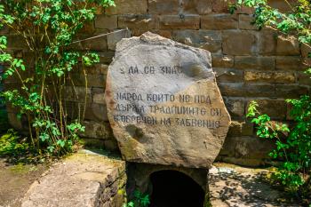 Memorial stone in the Etar Architectural Ethnographic Complex in Bulgaria on a sunny summer day