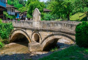 Stone bridge in the Etar Architectural Ethnographic Complex in Bulgaria on a sunny summer day