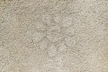 Texture of a wall from the made foam plaster. Types of external coverings of the building.