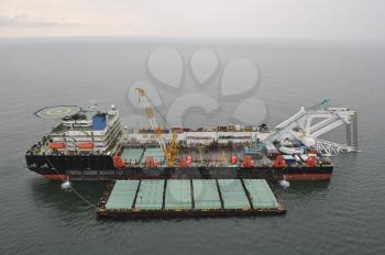 The cargo ship with the crane, the top view. Pipelaying barge.