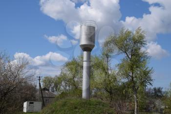 Rusty water tower. An old rustic communal communication.