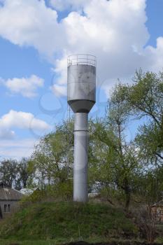 Rusty water tower. An old rustic communal communication.