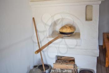 Bread in the Russian oven. Recreated image of antiquity.