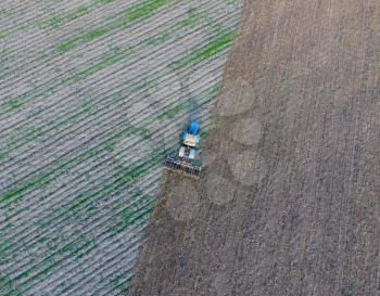 Top view of the tractor that plows the field. disking the soil. Soil cultivation after harvest.