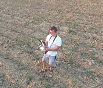 The man is holding a remote control from the quadrocopters. Photographer's work with gadgets.