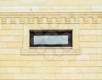 Background of yellow brick and windows. Wall of yellow bricks with a plastic window. The texture of the wall.