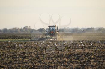 Tractor plowing plow the field. Tilling the soil in the fall after harvest. The end of the season.