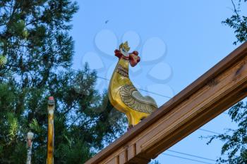 Wooden figures of birds on a wooden arch. Woodcarving Art.