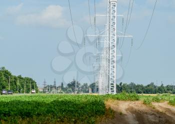 Transmission tower on a background field of soybeans.
