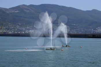 Fountains in the sea. Spray fountains in the bay. Sea port.
