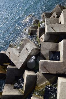 Breakwater blocks in the port. Breakwater of the rectangular stone figures.