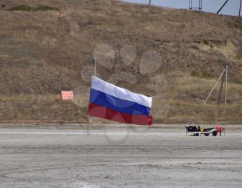 Russia, Veselovka - September 6, 2016: Russian flag on the bottom of a salty lake. Attributes country.