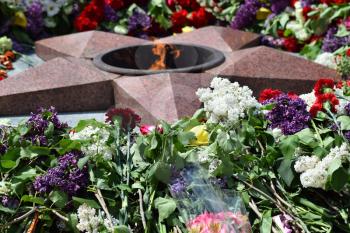 Eternal flame with flowers assigned to it. Celebration of May 9 Victory in the Great Patriotic War.