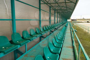 Rows of seats in an empty stadium. Green seats at the stadium.