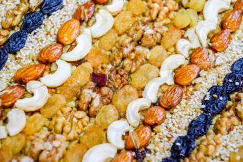 Kozinaki covered with nuts and seeds. Almonds, cashews and raisins