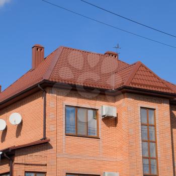 Decorative metal tile on a roof. Types of a roof of roofs. Decorative metal on the roof of the house.