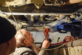 Krasnodar, Russia - April 22, 2017: Oil change in the automatic box of the car Volkswagen Tuareg. Car maintenance station.