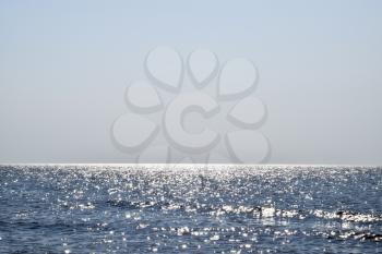 Sea line of the horizon. Sea and sky. The waves and glare of the sun are reflected from the waves of the sea. Seascape